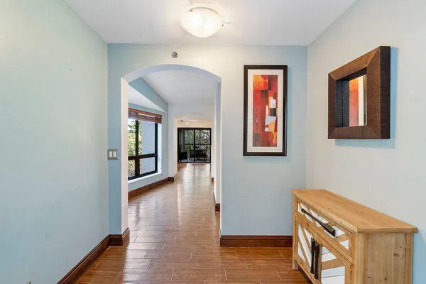 a view of a room with large windows and stairs