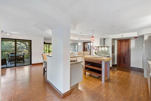 a kitchen with granite countertop a sink stove and wooden cabinets