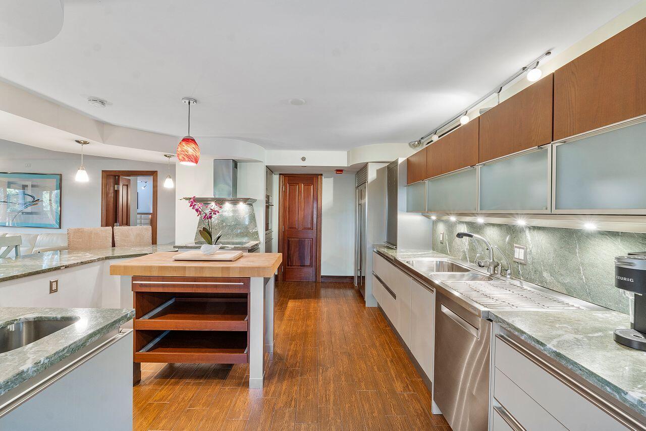 500 Ocean Trail Way, Unit 201 Jupiter, FL 33477 - Photo 9 of 58 a kitchen with stainless steel appliances granite countertop a sink a stove and a wooden floors