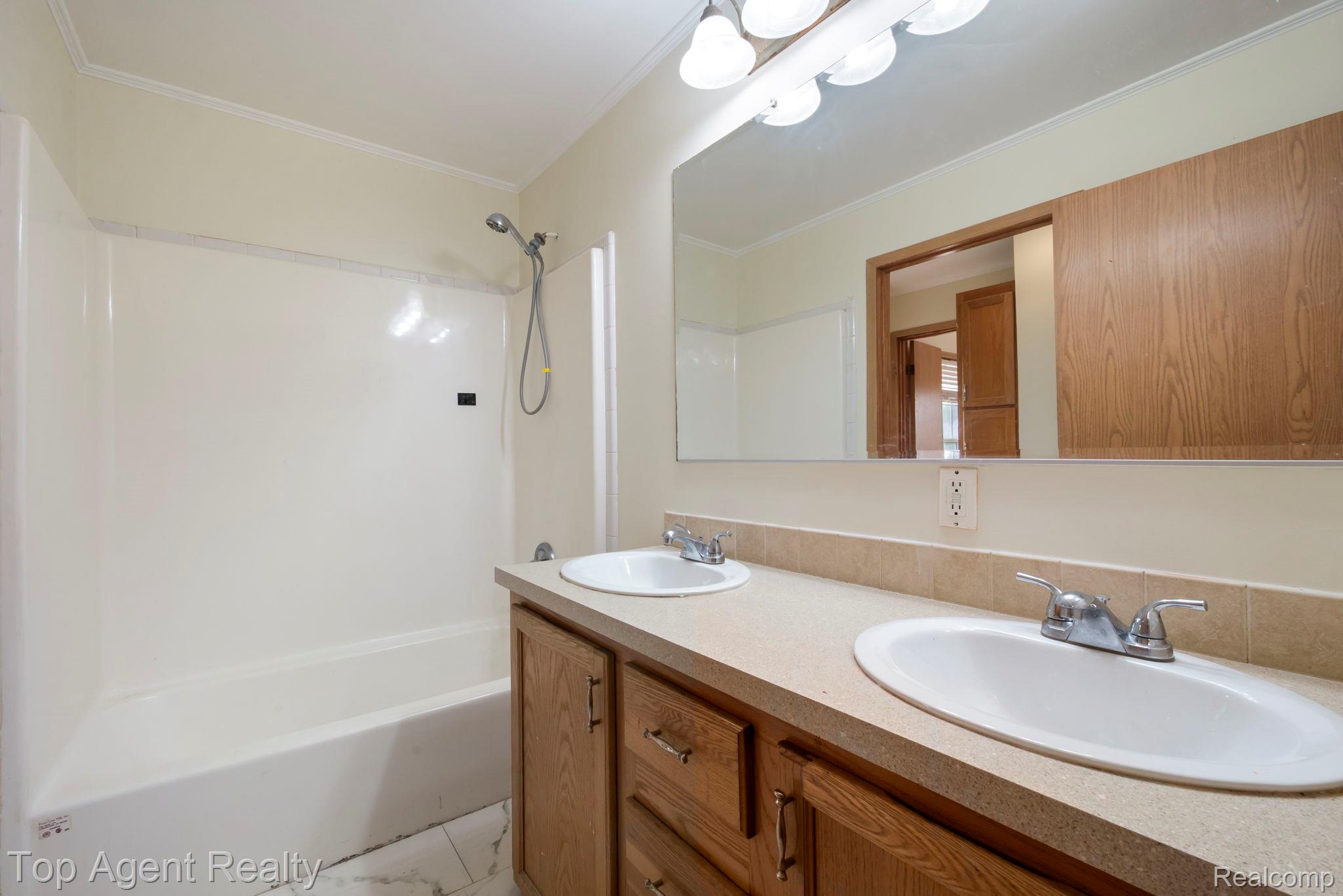 2018 John R Road Troy, MI 48083 - Photo 16 of 30 Full bathroom featuring double vanity, shower combination, and crown molding