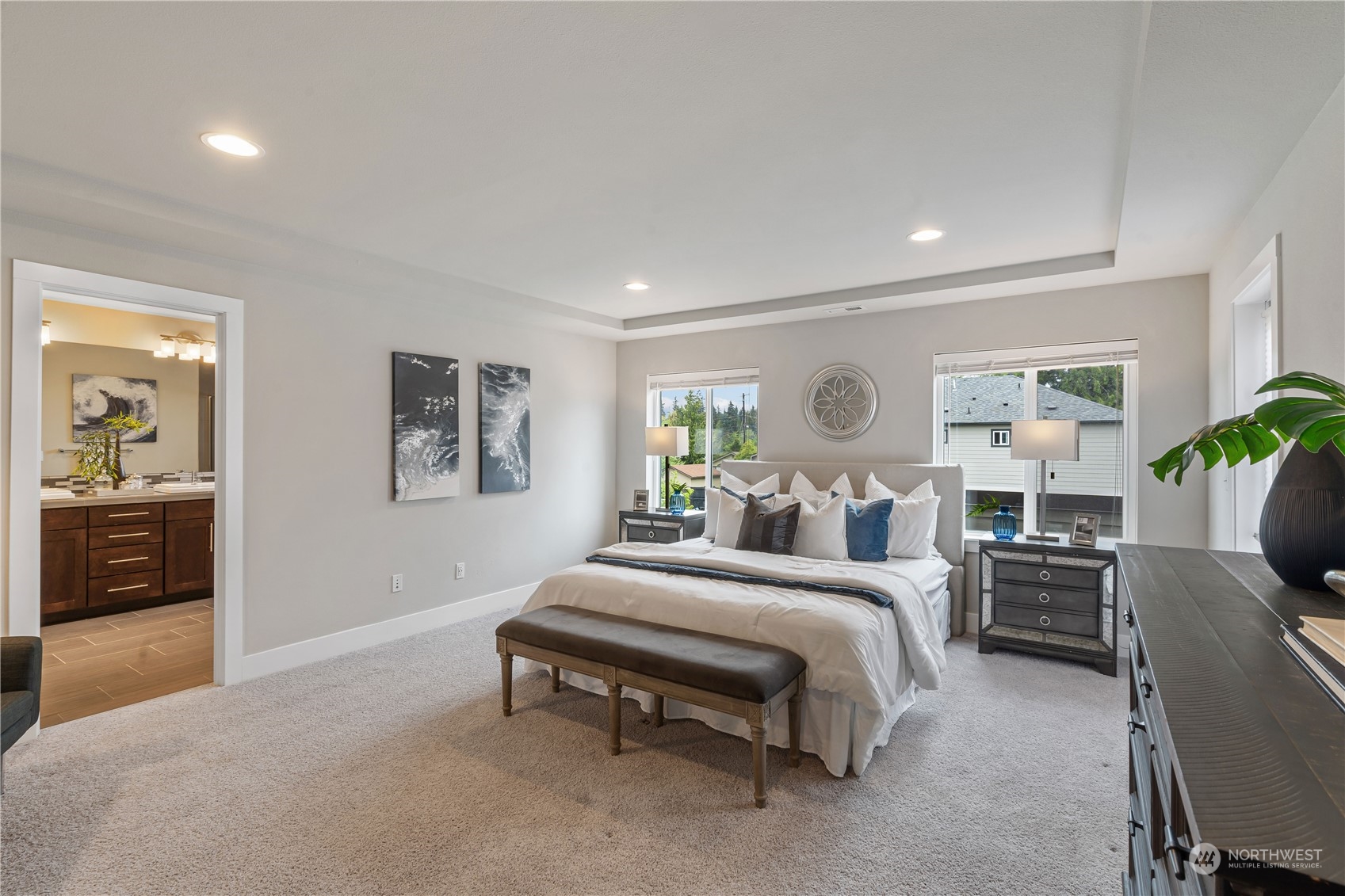 114 176th Place Southwest Bothell, WA 98012 - Photo 19 of 31 a spacious bedroom with a bed a table and painting
