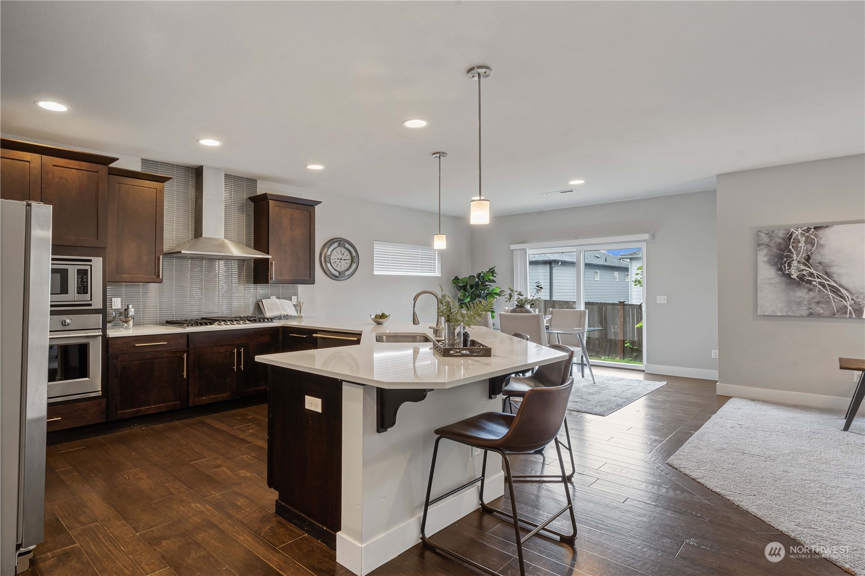 114 176th Place Southwest Bothell, WA 98012 - Photo 7 of 31 a kitchen with kitchen island stainless steel appliances a sink a stove a table and chairs