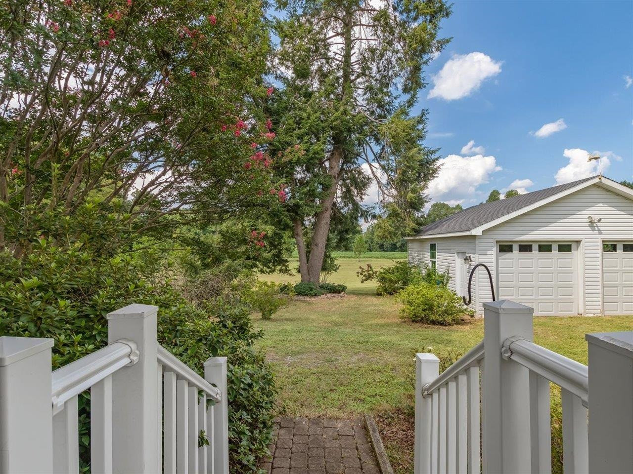 5609 Dona Road Julian, NC 27283 - Photo 17 of 63 a view of a house with a yard and potted plants