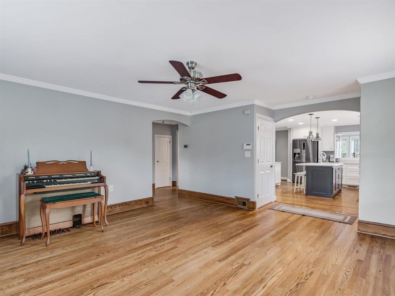 5609 Dona Road Julian, NC 27283 - Photo 18 of 63 a living room with furniture a piano and wooden floor