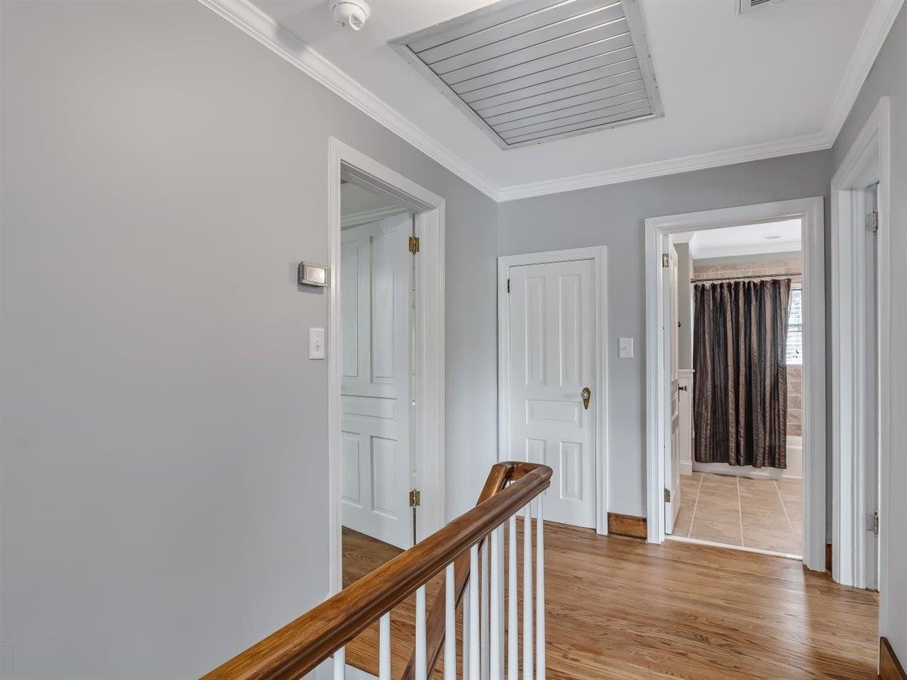 5609 Dona Road Julian, NC 27283 - Photo 40 of 63 a view of a hallway with wooden floor and staircase