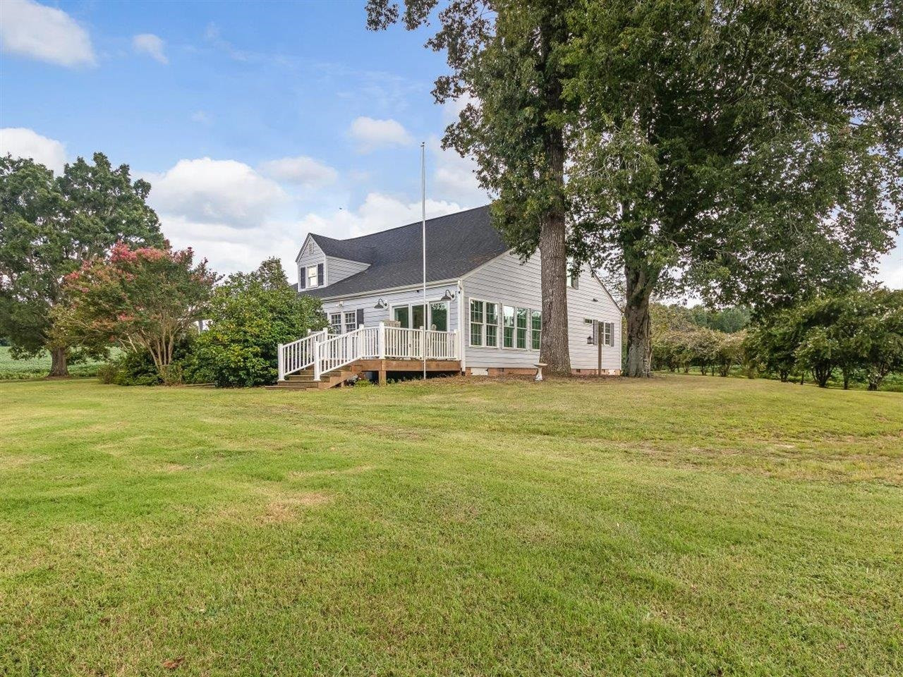 5609 Dona Road Julian, NC 27283 - Photo 49 of 63 a front view of a house with a garden and trees