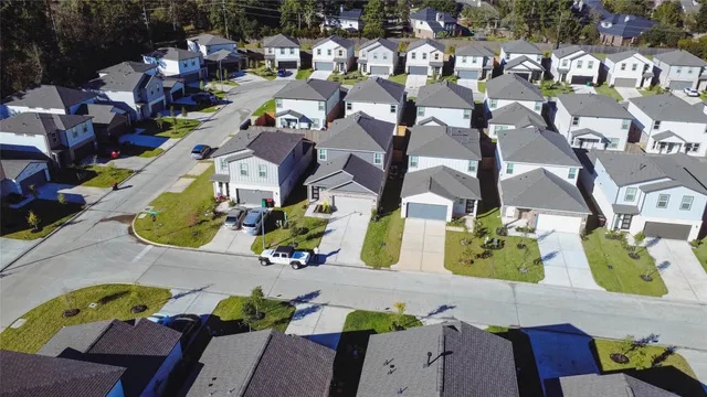 an aerial view of residential houses with outdoor space