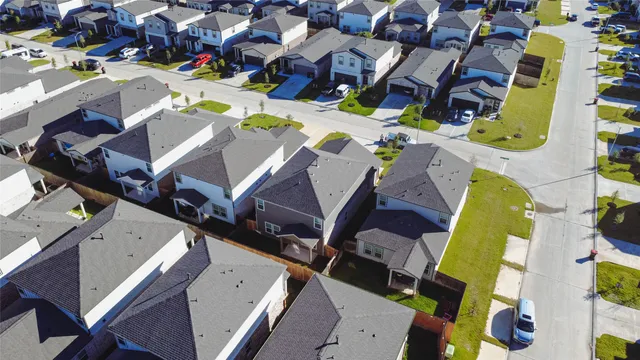 an aerial view of a house with a swimming pool and outdoor seating