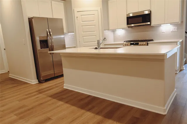 a kitchen with appliances and cabinets