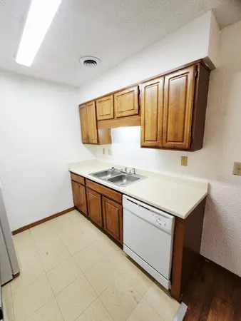 a kitchen with stainless steel appliances granite countertop a sink and a stove top oven