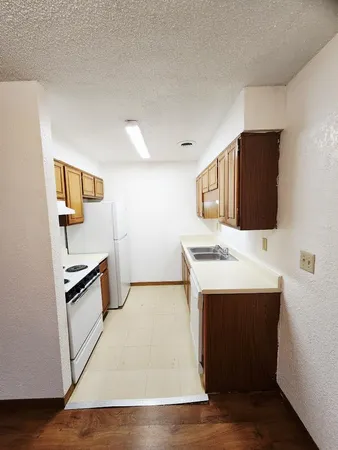 a kitchen with stainless steel appliances a stove and a refrigerator
