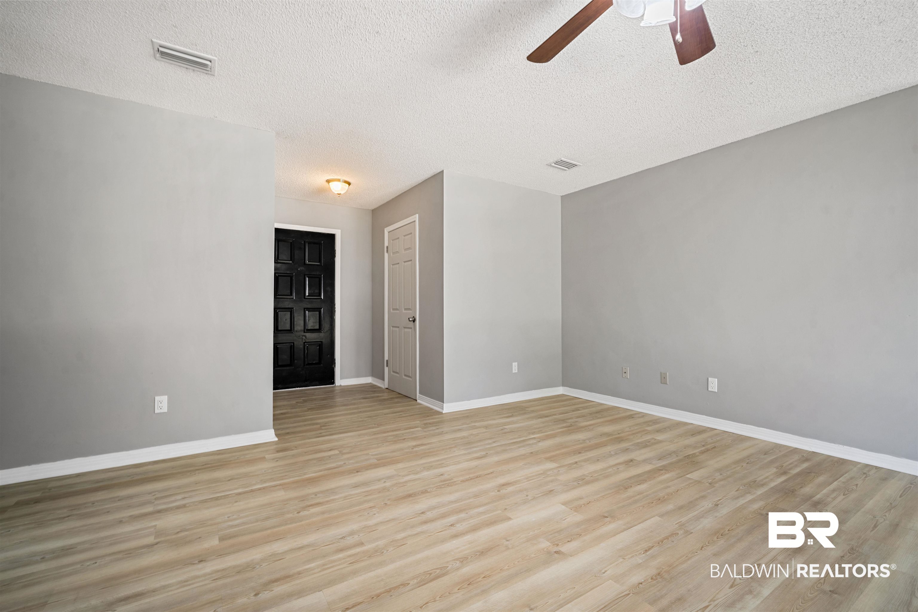 12910 Del Rio Street Grand Bay, AL 36541 - Photo 5 of 26 Spare room with light wood finished floors, a textured ceiling, and ceiling fan