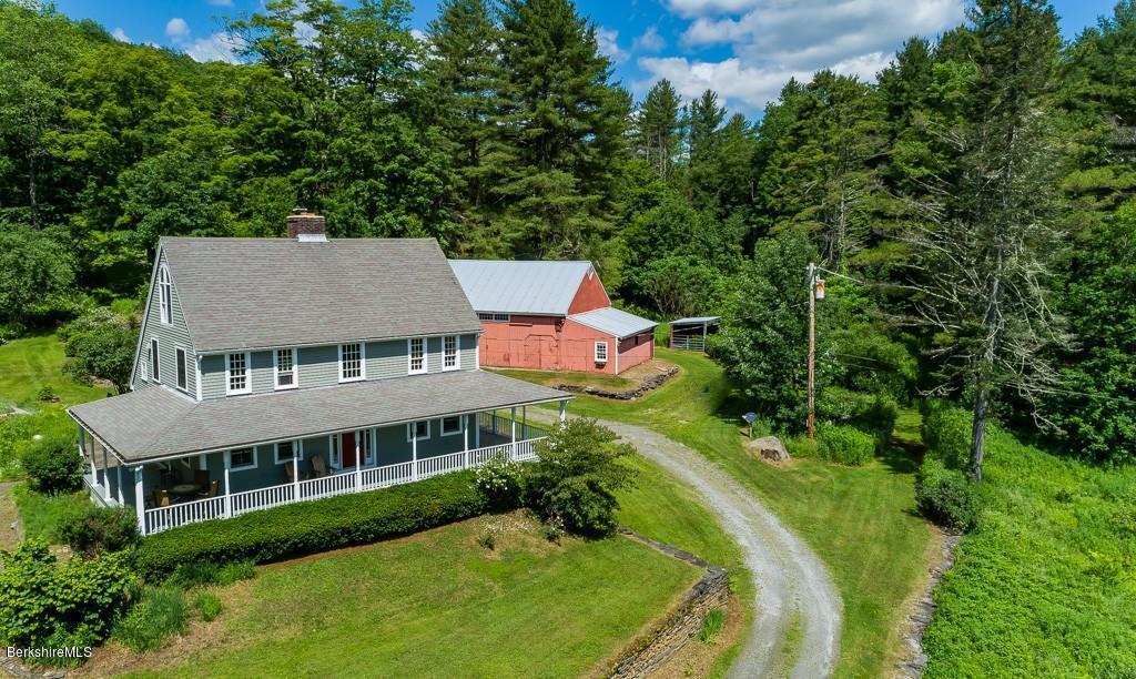 430 East River Road Chester, MA 01011 - Photo 3 of 42 an aerial view of a house with a yard table and chairs