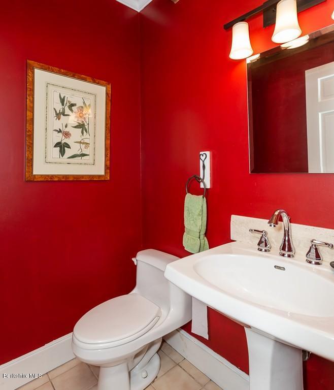430 East River Road Chester, MA 01011 - Photo 27 of 42 a bathroom with a toilet a sink and mirror