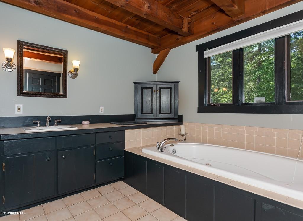 430 East River Road Chester, MA 01011 - Photo 30 of 42 a spacious bathroom with a tub a sink and mirror