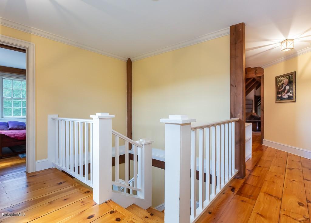 430 East River Road Chester, MA 01011 - Photo 32 of 42 a view of staircase with lots of frames on wall and wooden floor
