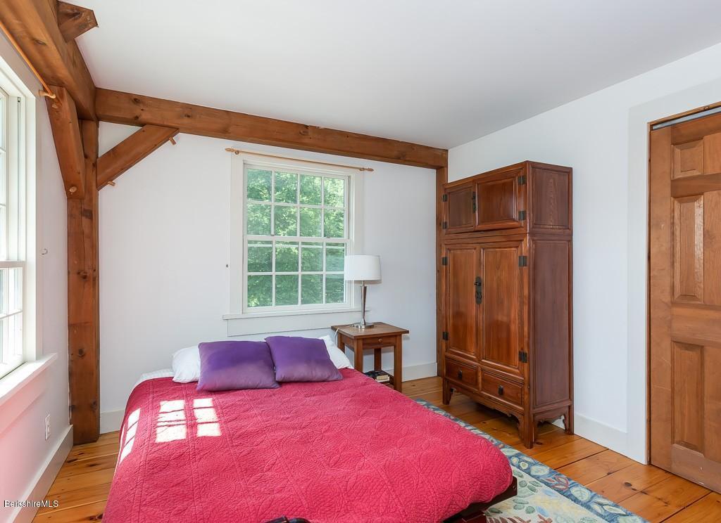 430 East River Road Chester, MA 01011 - Photo 33 of 42 a bedroom with a bed and wooden floor