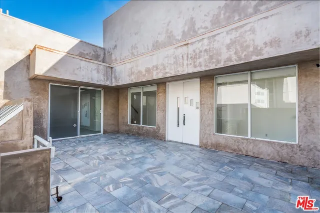 a view of a brick house with a large window