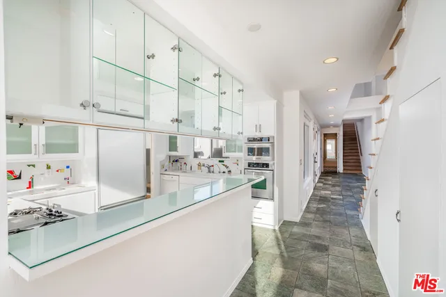 a view of a kitchen with kitchen appliances
