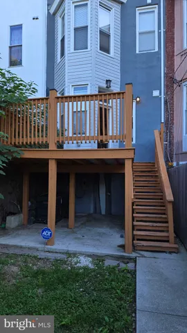 a backyard of a house with barbeque oven and outdoor seating