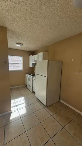 a kitchen with a cabinets and white appliances