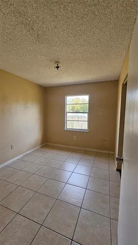 a view of an empty room and a window