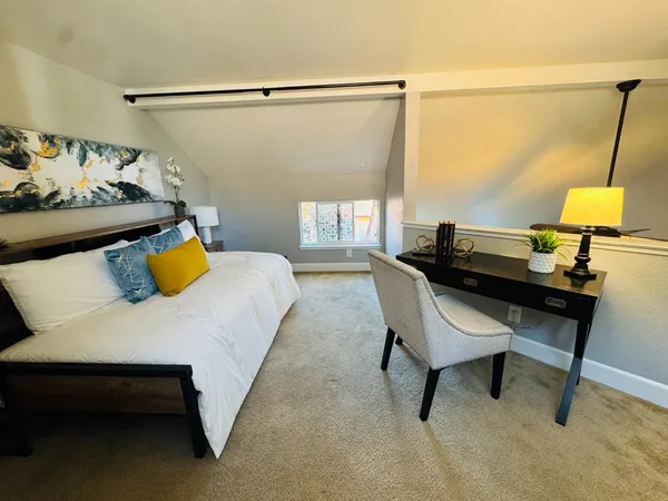 a bedroom with a bed and a table