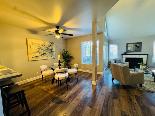 a living room with fireplace furniture and a wooden floor