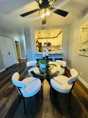 a view of a dining room with furniture and wooden floor
