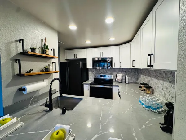 a kitchen with refrigerator and cabinets