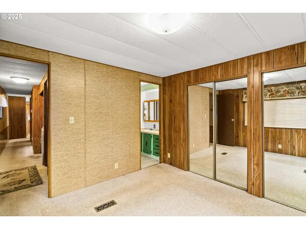 a bedroom with a bed and a mirror