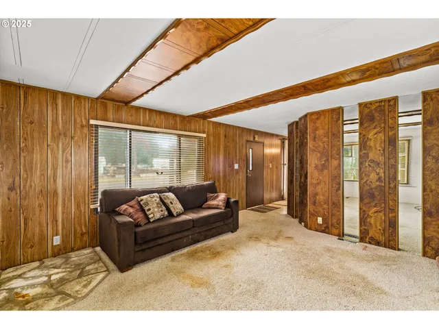 a living room with furniture and large windows