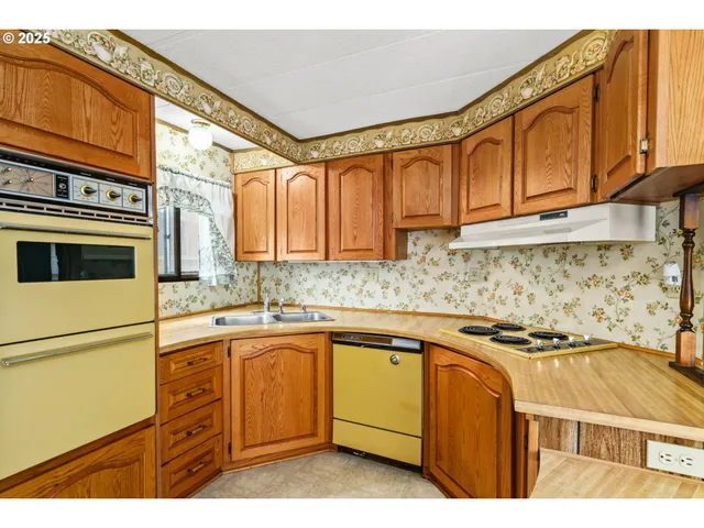 a kitchen with stainless steel appliances granite countertop a sink and cabinets