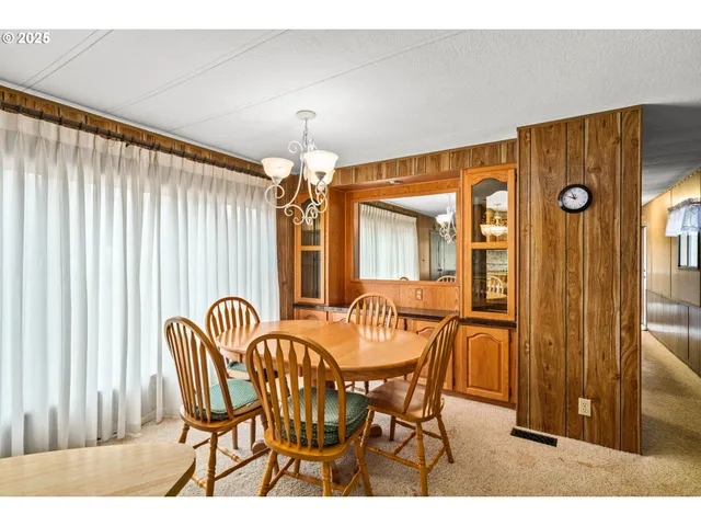 a view of a dining room with furniture and chandelier