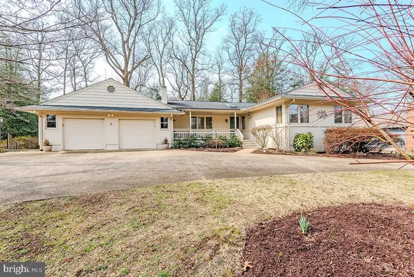 a front view of a house with a yard covered in snow