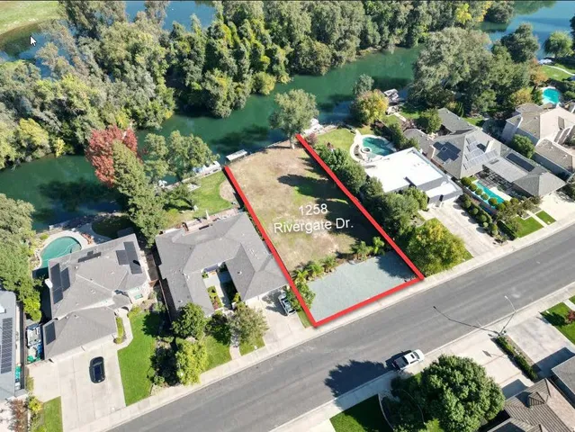 an aerial view of a house with a yard and potted plants