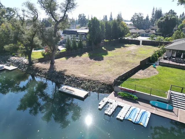 a view of river covered by trees and houses