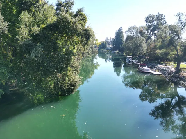 an aerial view of lake residential house with outdoor space and trees around