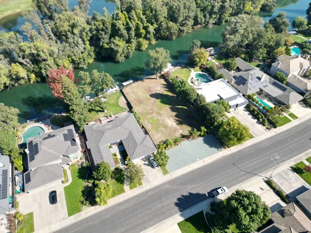 an aerial view of a house with a yard and garden