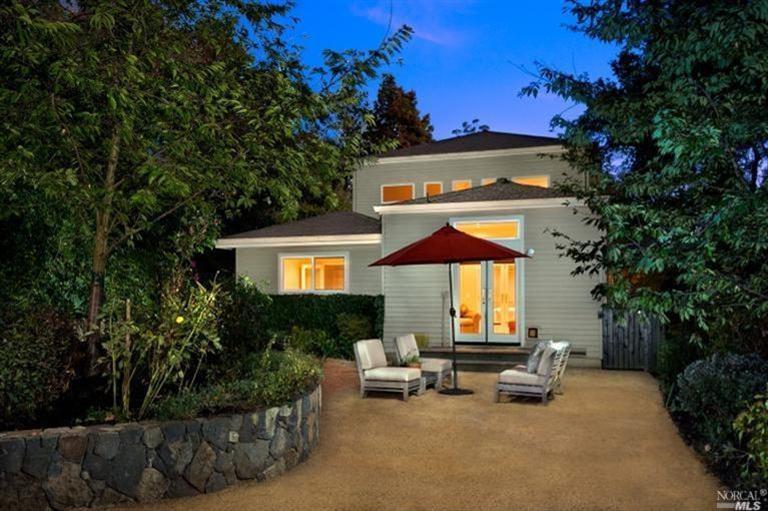 a view of a house with backyard and sitting area