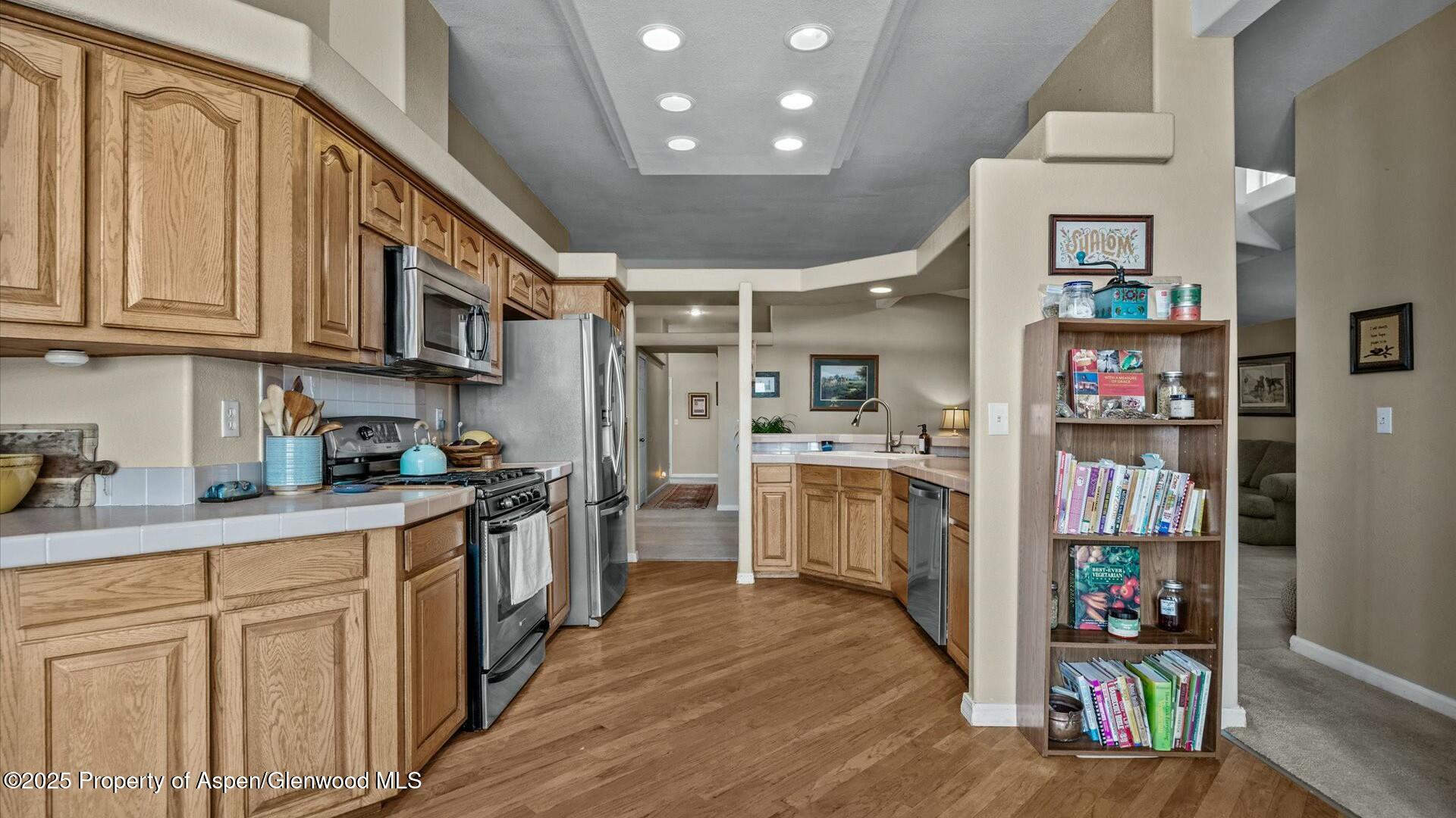 10479 50 Road Mesa, CO 81643 - Photo 11 of 42 a kitchen with stainless steel appliances granite countertop a refrigerator and a sink