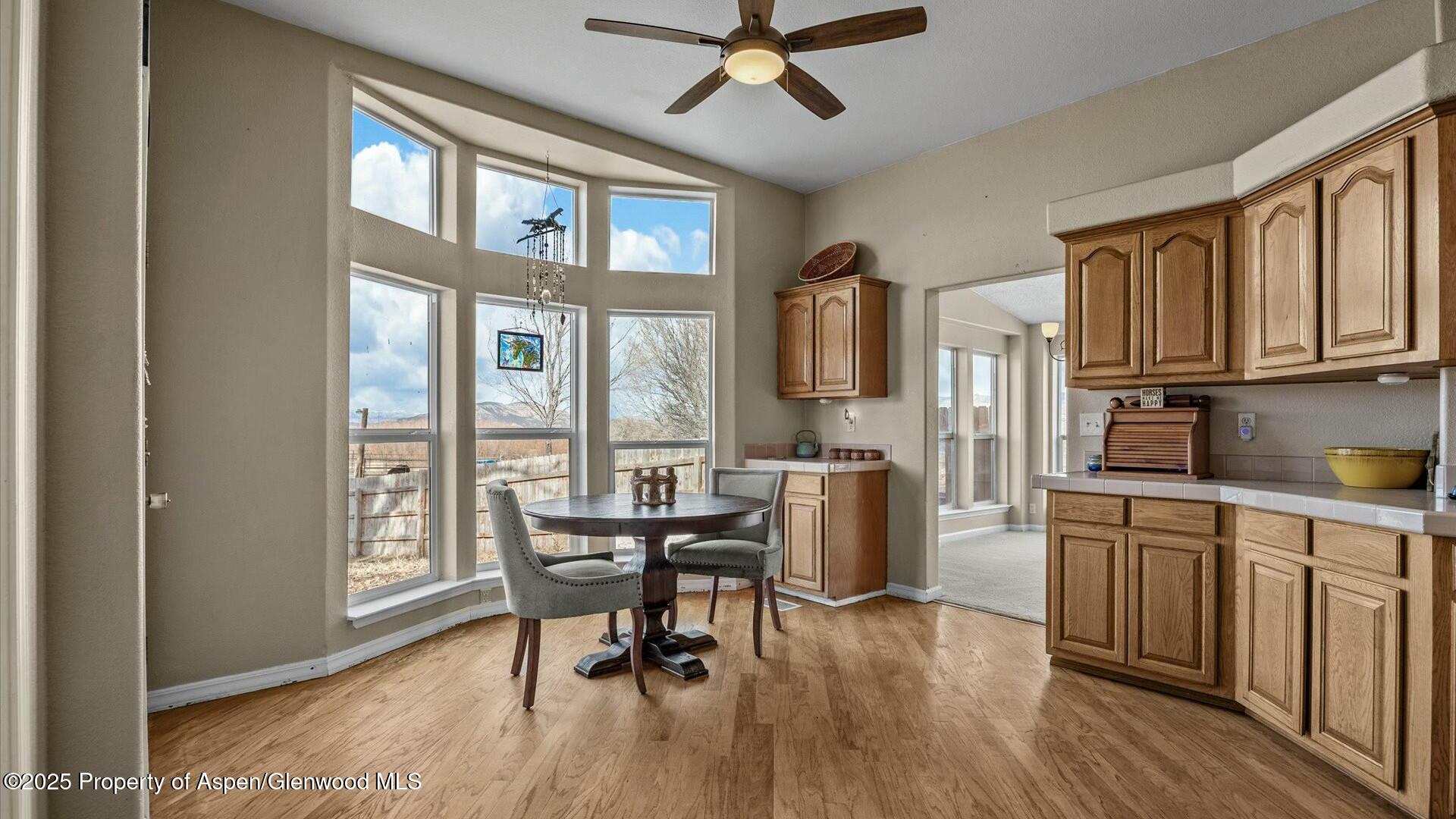 10479 50 Road Mesa, CO 81643 - Photo 12 of 42 a view of a dining room with furniture window and wooden floor