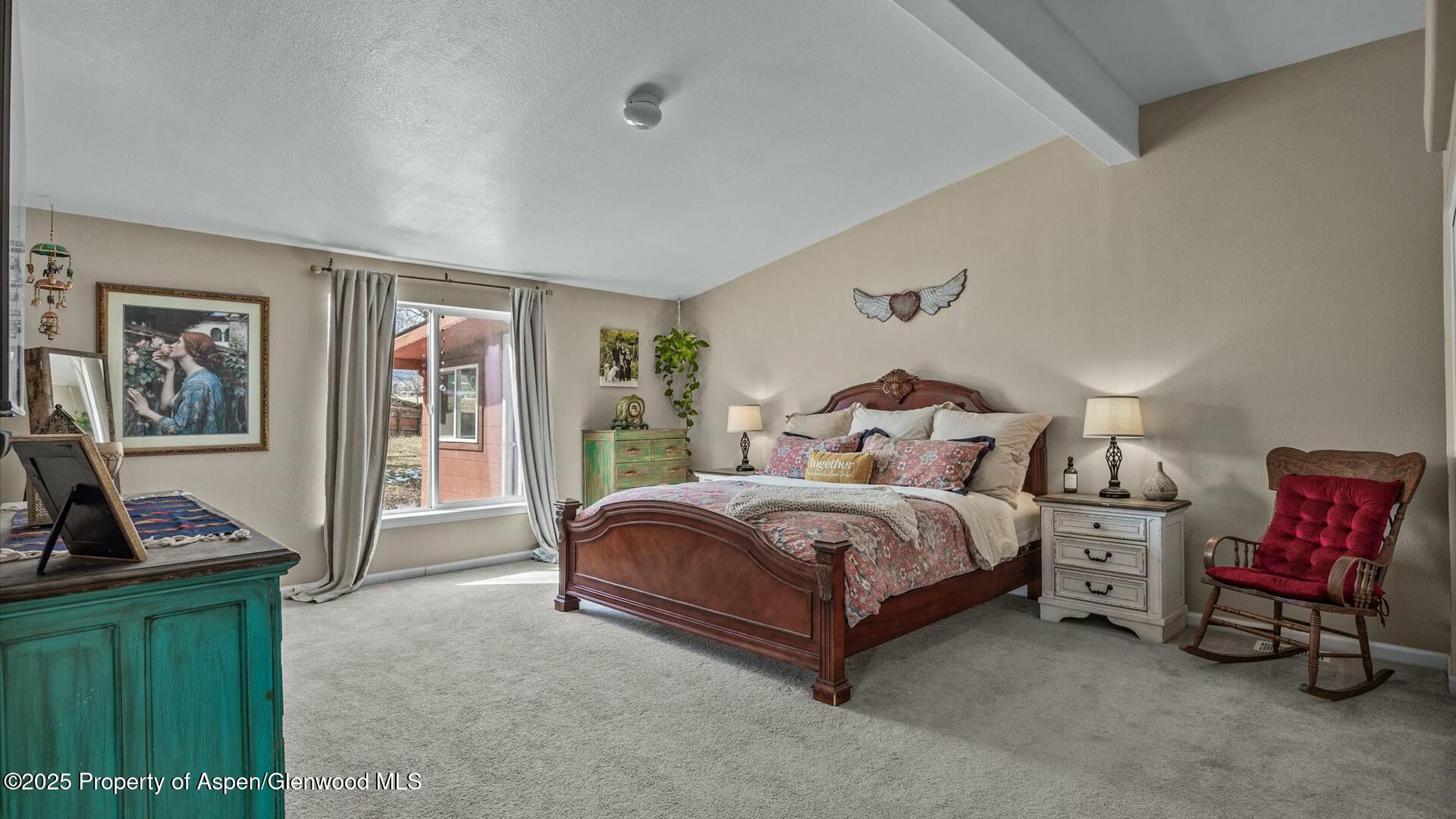10479 50 Road Mesa, CO 81643 - Photo 20 of 42 a spacious bedroom with a bed and wooden floor