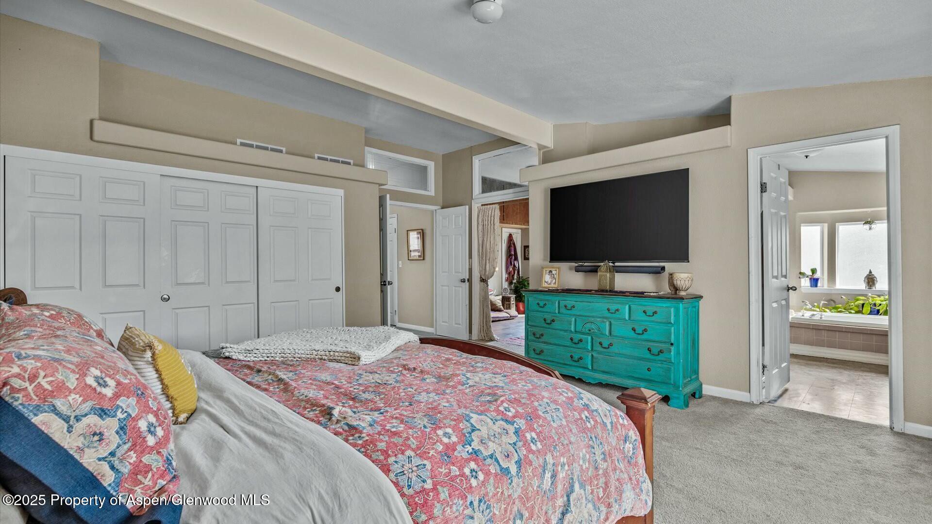 10479 50 Road Mesa, CO 81643 - Photo 21 of 42 a bedroom with a bed and a flat screen tv in it