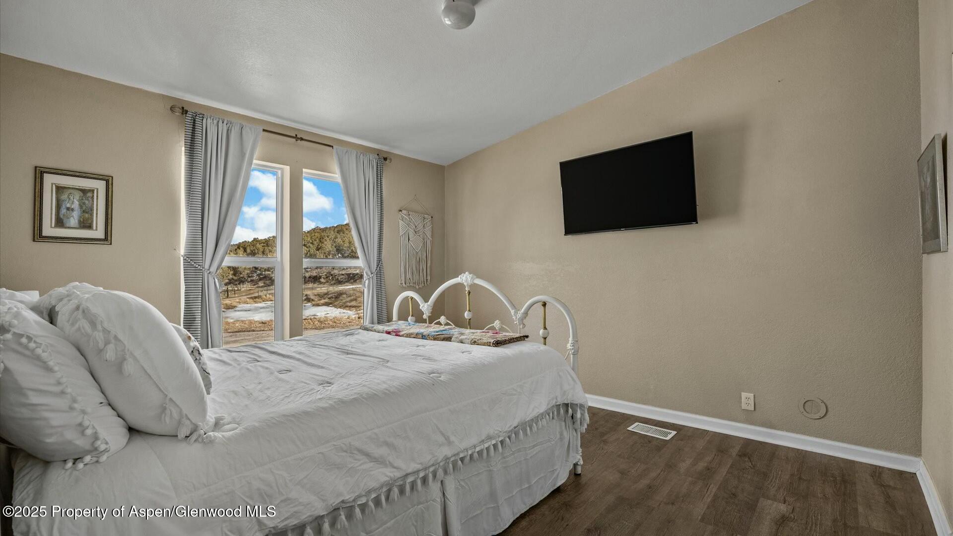 10479 50 Road Mesa, CO 81643 - Photo 25 of 42 a bedroom with a bed and a flat screen tv