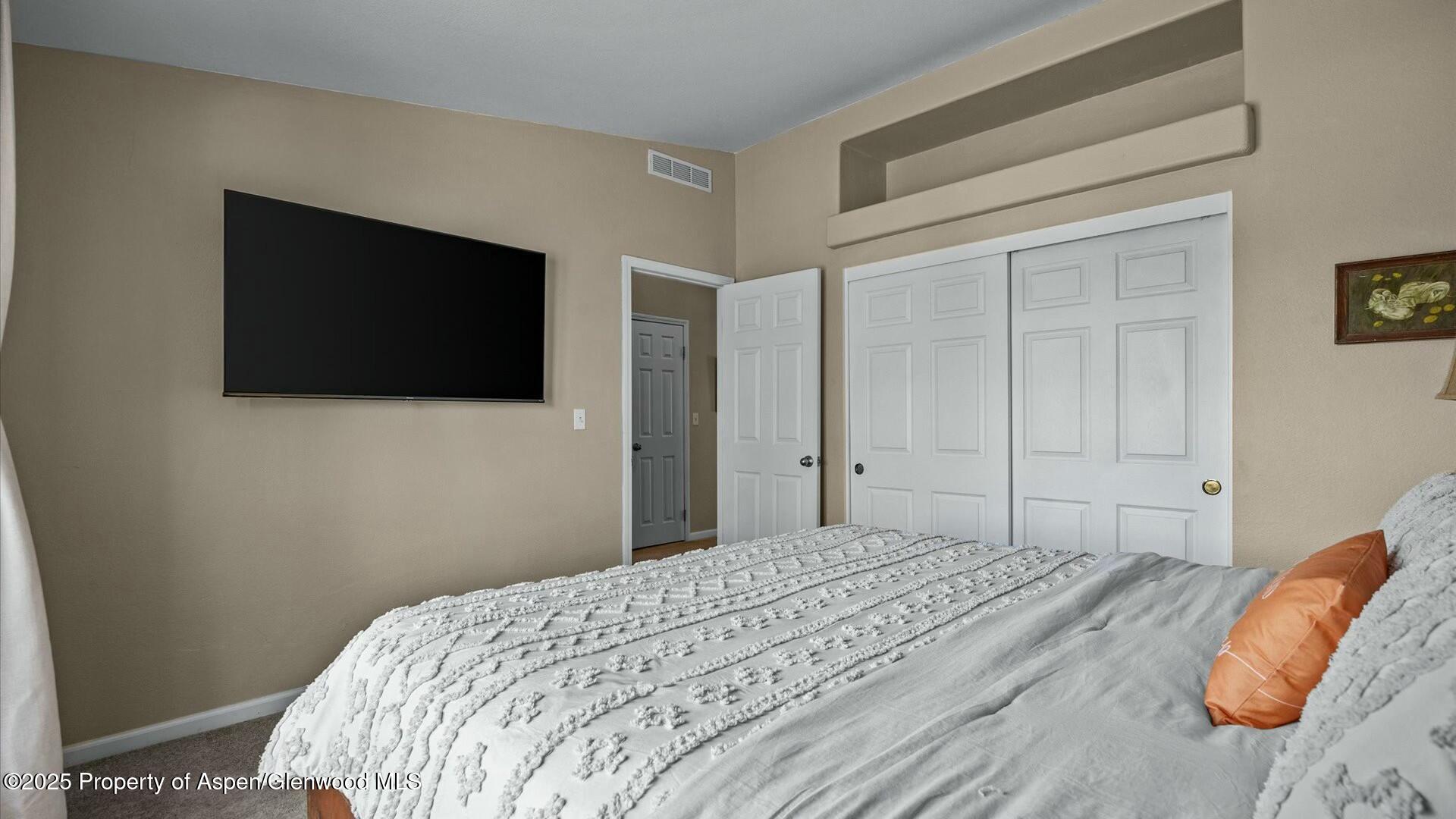 10479 50 Road Mesa, CO 81643 - Photo 26 of 42 a bedroom with a bed and a flat screen tv