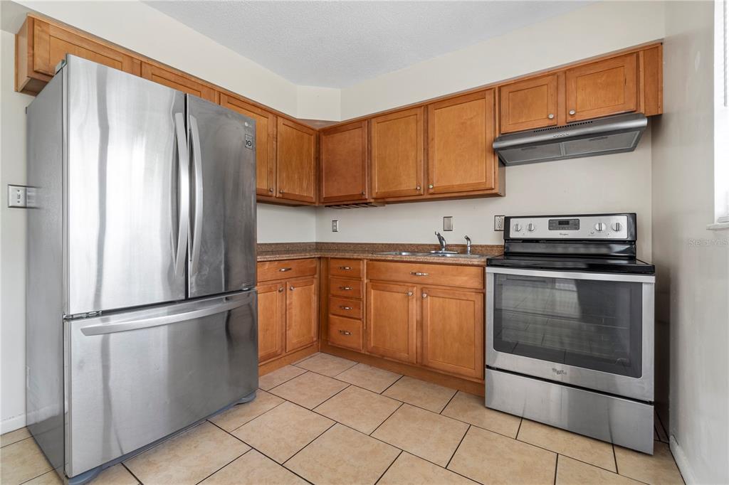 24 Bahia Loop Ocala, FL 34472 - Photo 2 of 9 a kitchen with stainless steel appliances granite countertop a refrigerator sink and cabinets