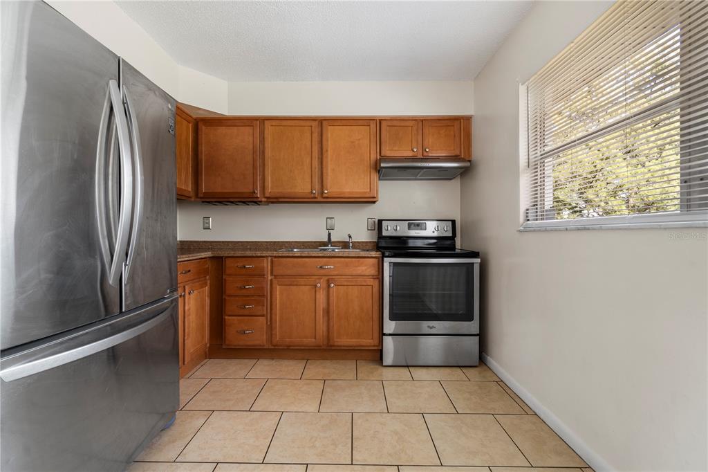 24 Bahia Loop Ocala, FL 34472 - Photo 3 of 9 a kitchen with a refrigerator sink and cabinets