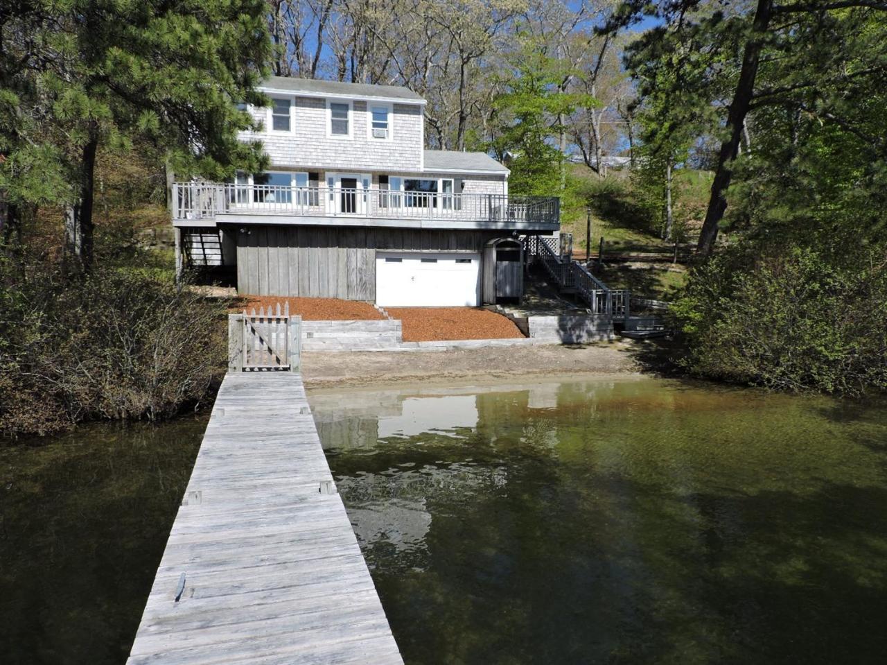 85 Huckins Neck Road Centerville, MA 02632 - Photo 1 of 23 a view of a house with a ocean view