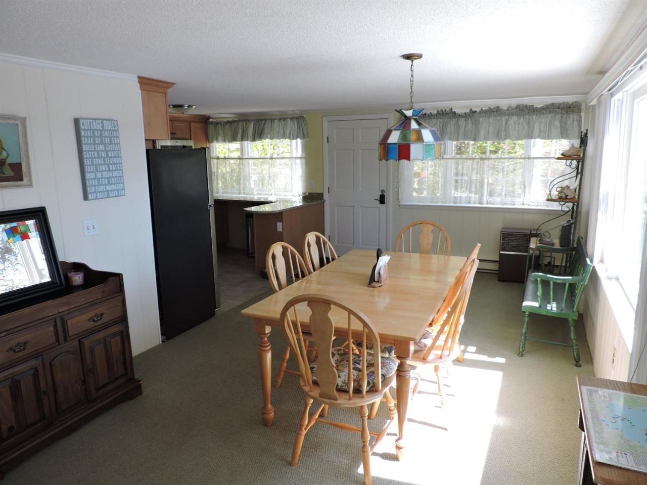 85 Huckins Neck Road Centerville, MA 02632 - Photo 13 of 23 a view of a dining room with furniture window and wooden floor